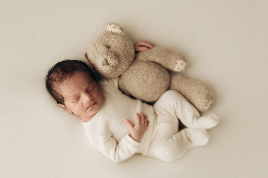 newborn baby boy with the stuffed bear