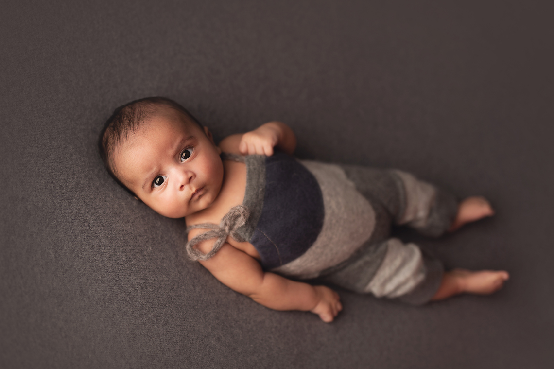 baby boy two month old on the grey backdrop
