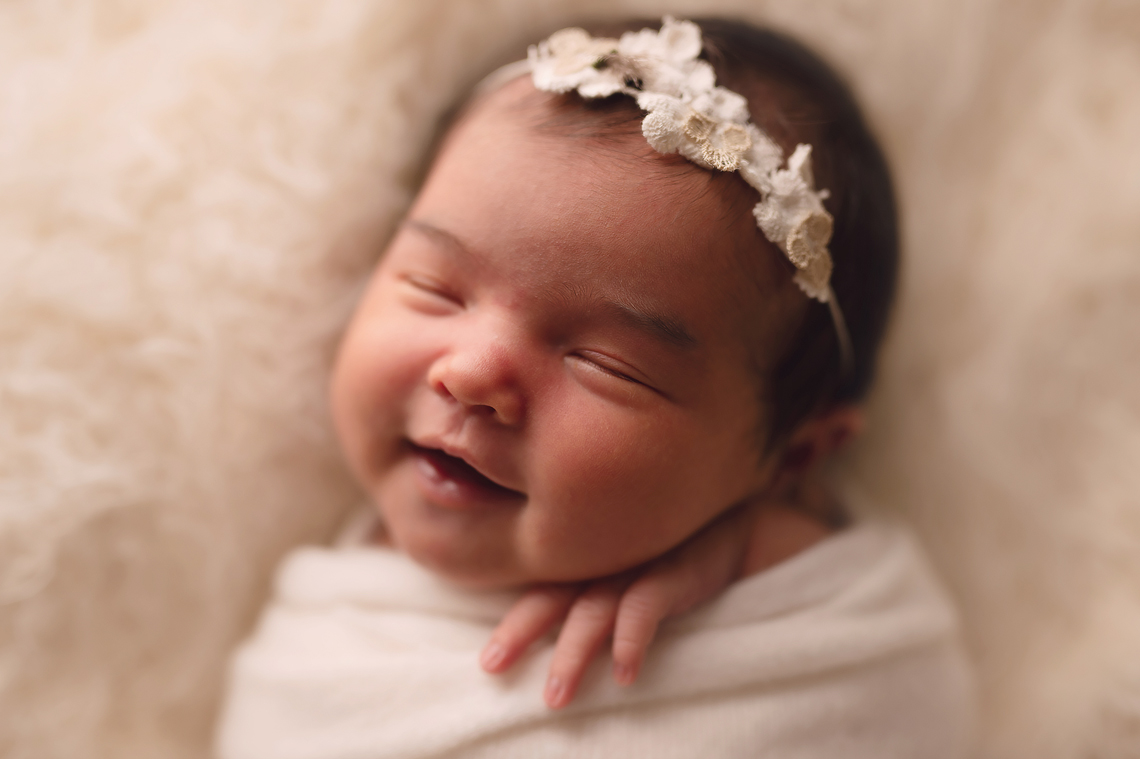 newborn baby girl portrait smiling