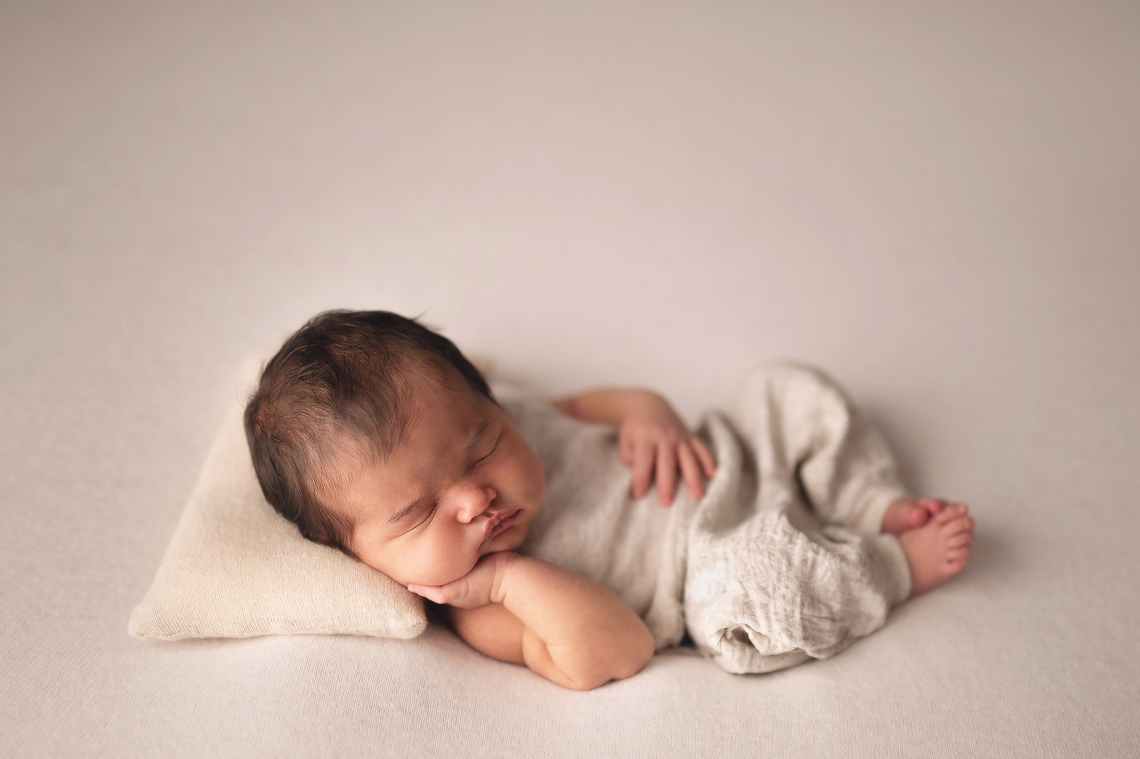 newborn baby girl wearing cute beige handmade outfit