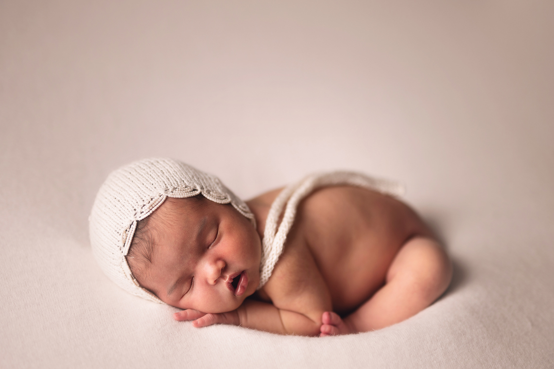 newborn baby girl wearing hand made hat with beets