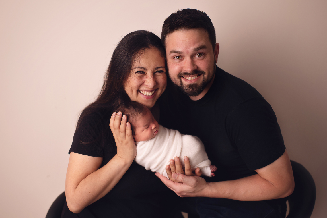 parents holding a newborn baby