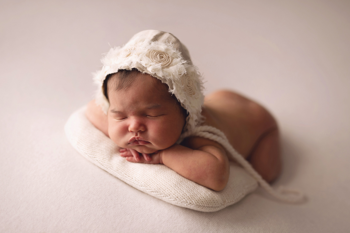 profile picture of newborn baby girl wearing hand made hat