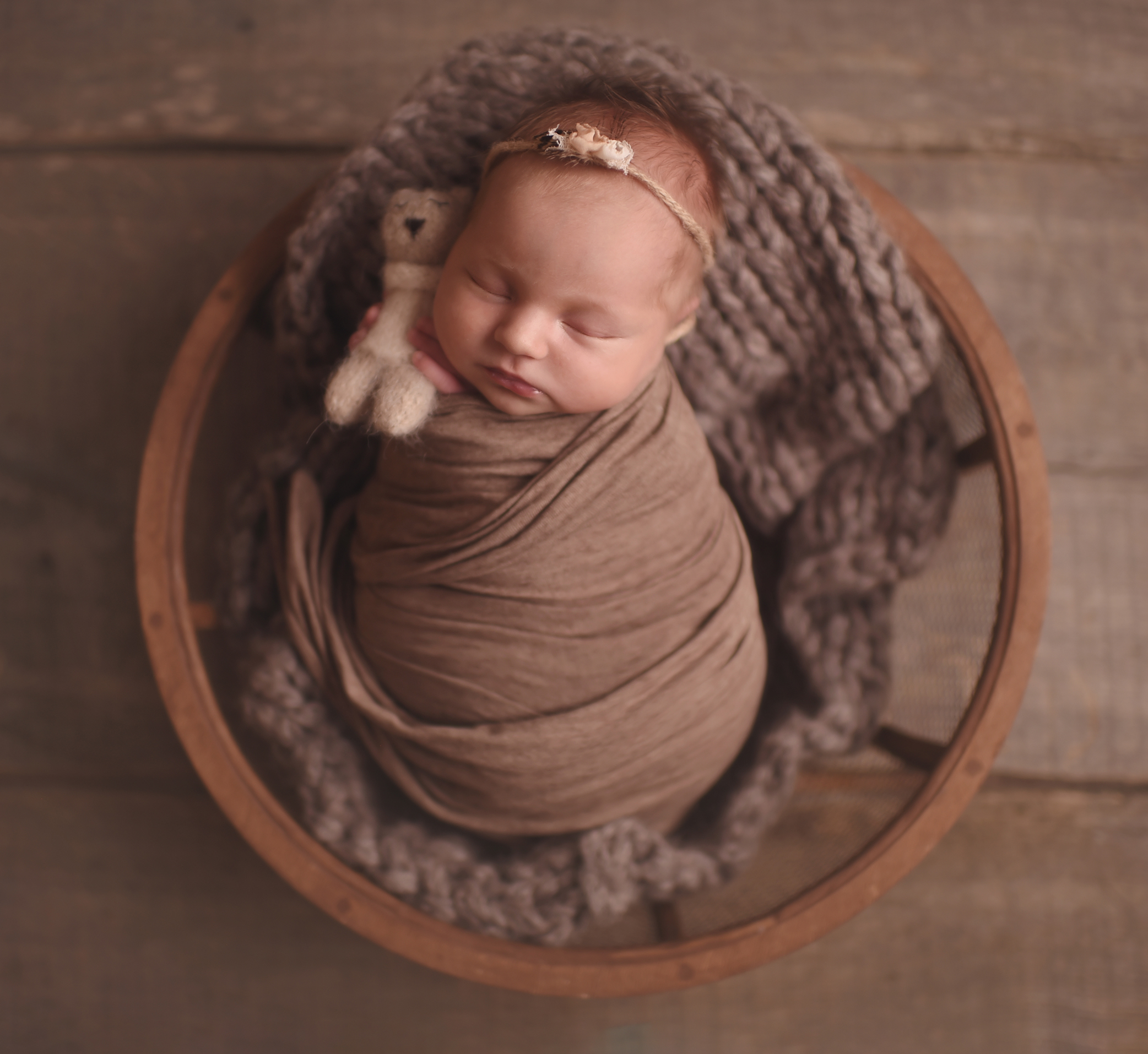 newborn baby girl in the wooden basket