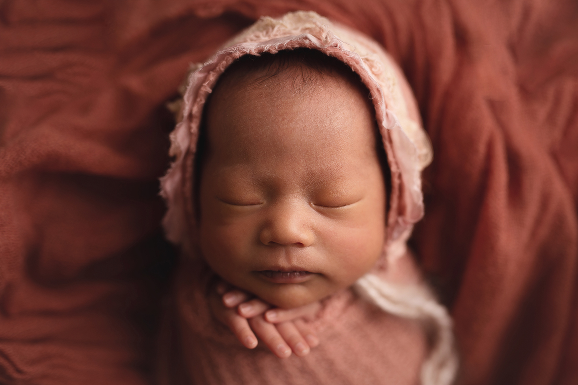 newborn baby girl sleeping on her back portraiture